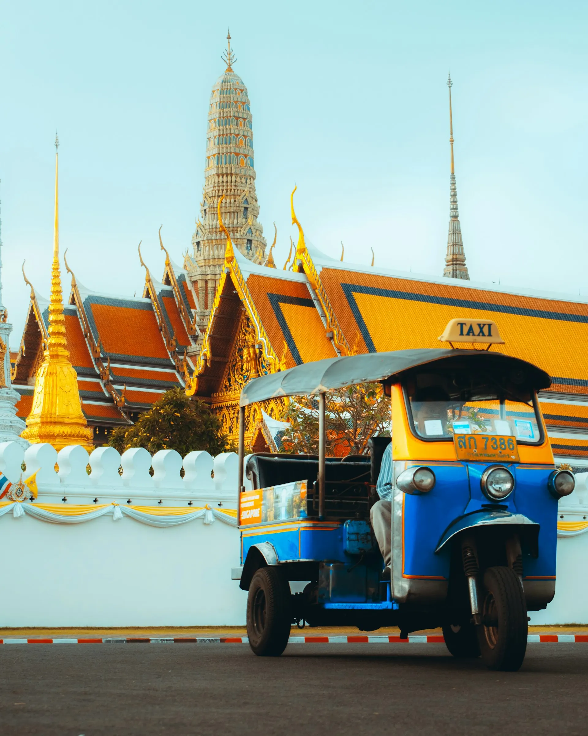 A tuk-tuk in front of the Grand Palace, Bangkok — get in touch with Gateway Siam